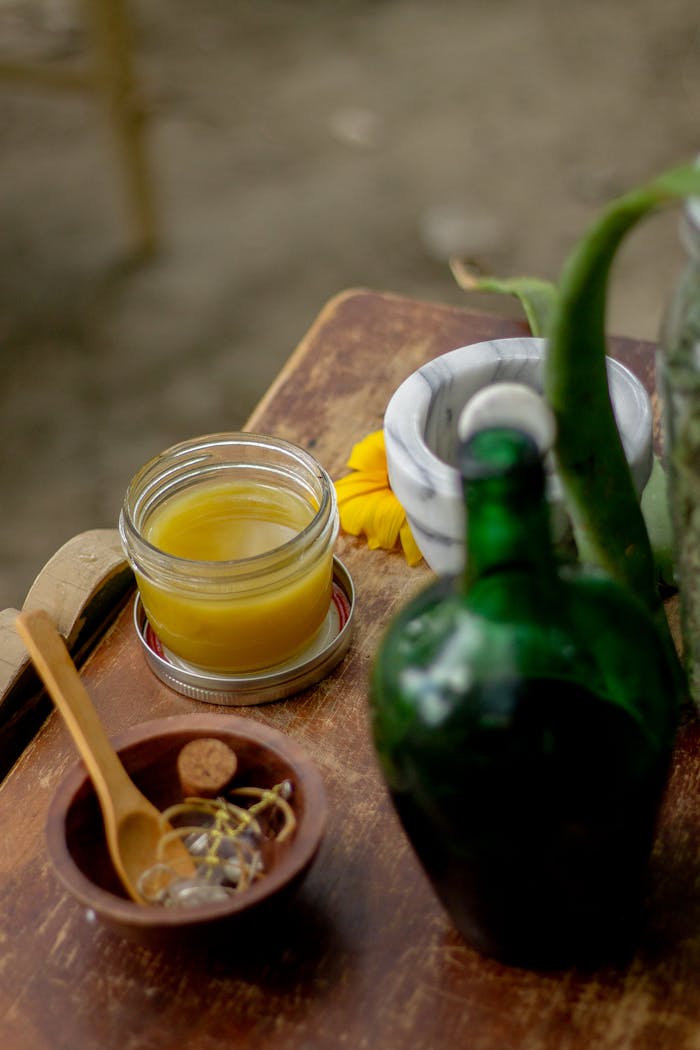 A collection of herbal remedies and natural ingredients on a rustic wooden table, evoking a sense of wellness and nature.